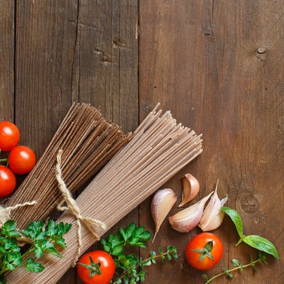 Three types of spaghetti, tomatoes and herbs