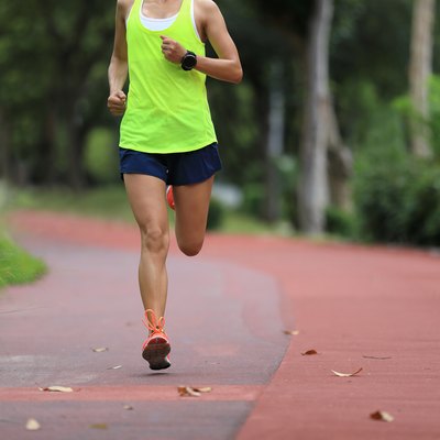 Fitness sporty woman jogger running at outdoors jogging track in park