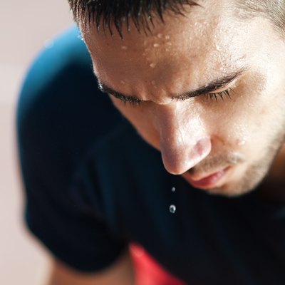 A male runner sweating profusely after a workout