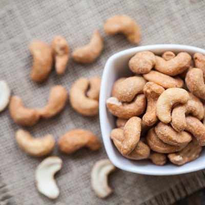Salted cashew nuts in bowl on sackcloth