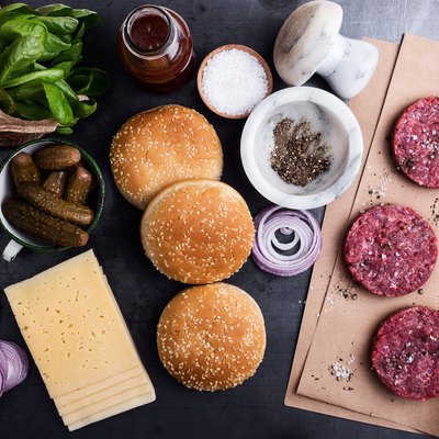 Raw beef meat burger cutlets with ingredients
