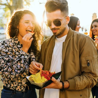 Group of friends eating snacks outside