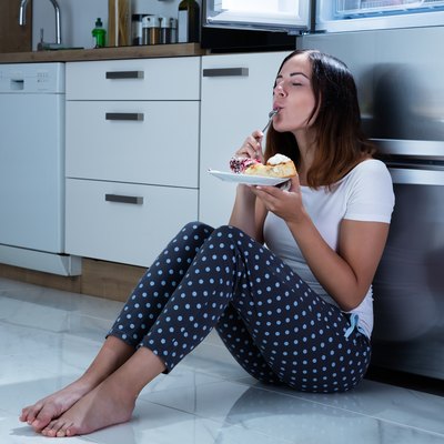 Woman Enjoy Eating Sweet Food In Kitchen