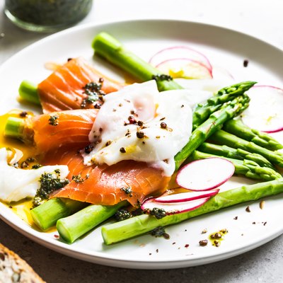 Smoked salmon with poached egg and asparagus delivering protein to prevent hair loss
