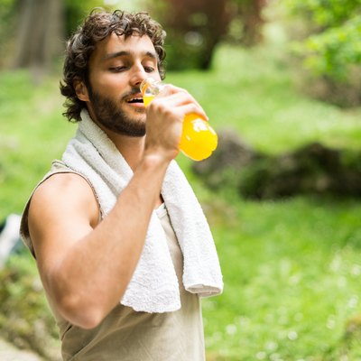 A man drinking a sports drink with electrolytes after a workout