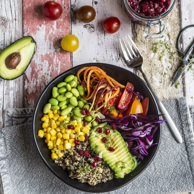 Quinoa vegetable bowl of avocado, Edamame, tomatoes, corn, carrots, red cabbage and pomegranate seed