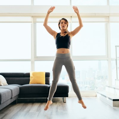 Adult Woman Training Legs Doing Squat and Jumping