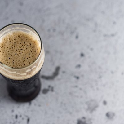 A glass of strong dark beer of the porter view from above copyspace
