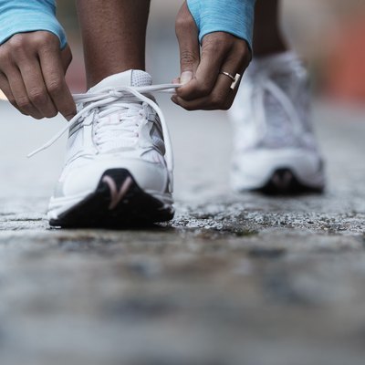 Mixed race runner tying shoelaces