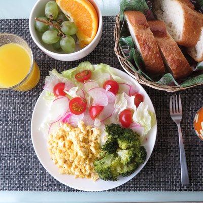 Scrambled egg breakfast with salad, fruit, coffee