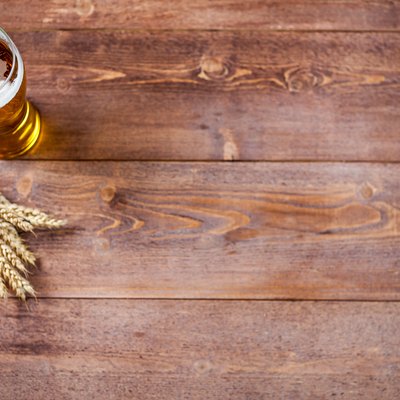 Glass of beer with wheat on a wooden table background with copy space for text. flat lay, top view