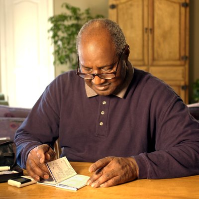 Man reading manual for blood test kit