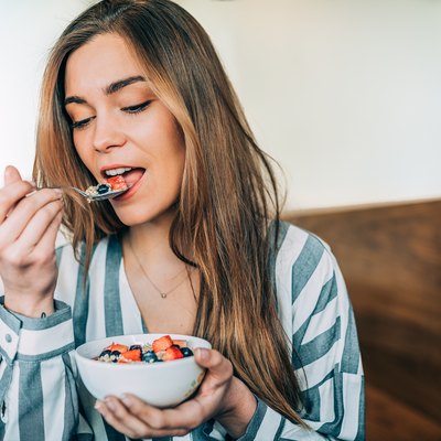 woman close up eating oatmeal for breakfast