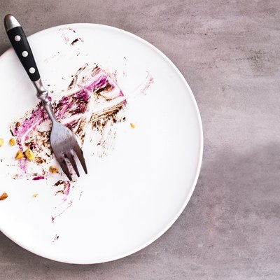 White empty plate with crumbs after fasting