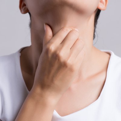 Sore Throat. Closeup Of Beautiful Young Woman Hand Touching Her Ill Neck. Healthcare and medical concept.