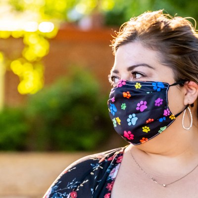 woman looking away weraing a colorful protective face mask