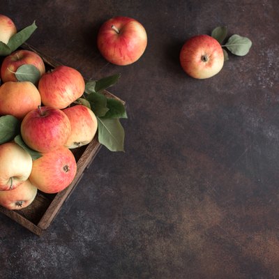 Red apples in wooden box
