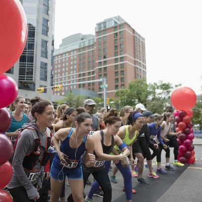 Marathon runners ready at starting line on urban street