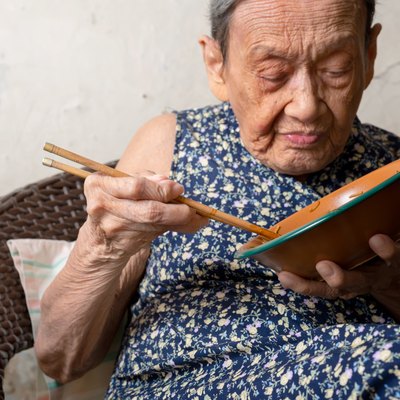 90 up of healthy old woman having lunch,front view.