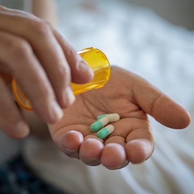 Man hand taking medicine