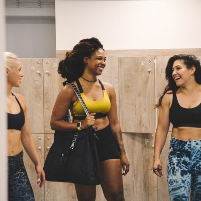 Women in a gym locker room getting ready for a workout