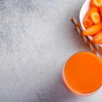 Glass of carrot juice, top view