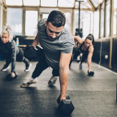 A man working out with dumbbells in the gym