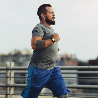 Man measuring his heart rate while running