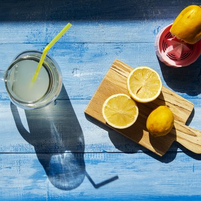 Lemons and citrus squeezer on a wooden background