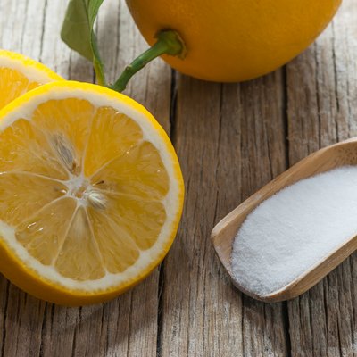 Lemon and Carbonate powder or baking soda on wooden table, alternative medicine, organic cleaner