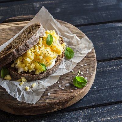 Scramble egg sandwich on rustic wooden background