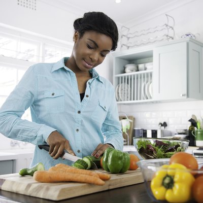 Woman chopping vegetables for healthy recipes