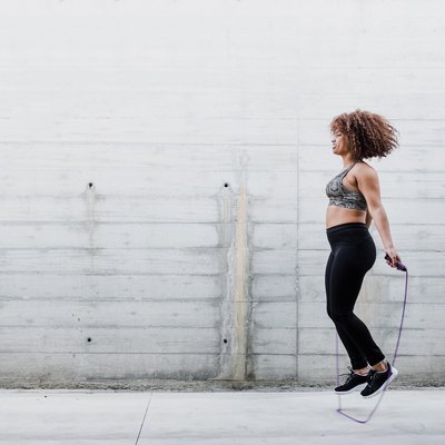 Curvy African American Woman Skipping Rope In Urban Area