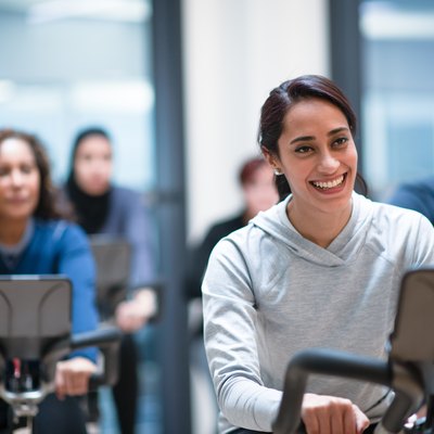 A diverse group of people doing a spin class