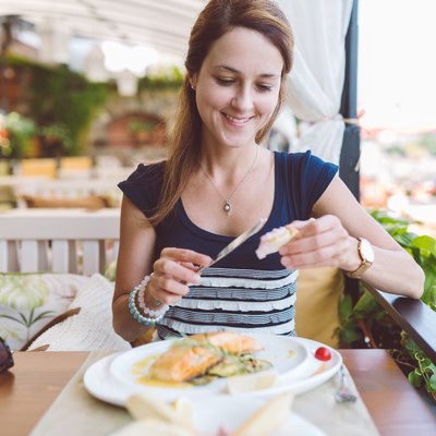 Woman eating seafood in restaurant