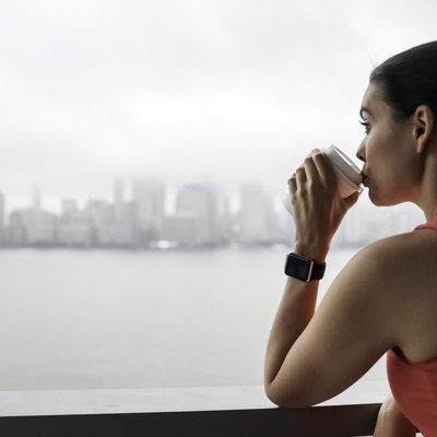 A young woman drinking coffee before a workout