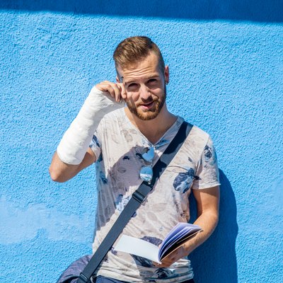Portrait of Handsome Young Man with Broken Arm