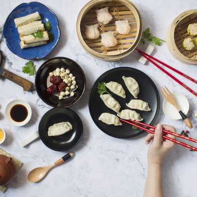 Flat lay Chinese new year reunion dinner, food and drink. Marble top background.