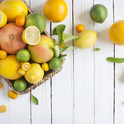 Citrus fruits family on rustic white wooden background. Horizontal view. Text space images.