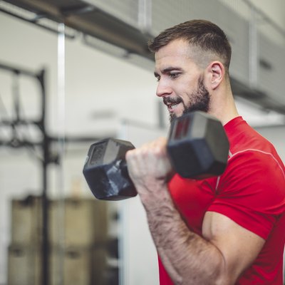 Strong man is doing cross training exercise