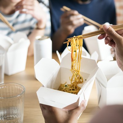 A family eating takeout food together at home