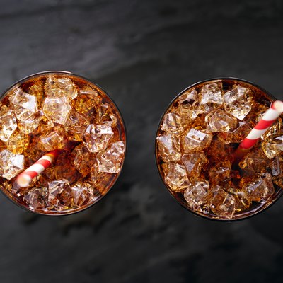 iced cola soda pop with straw in flay lay composition