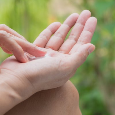 Cropped Image Of Woman Applying Lotion On Palm