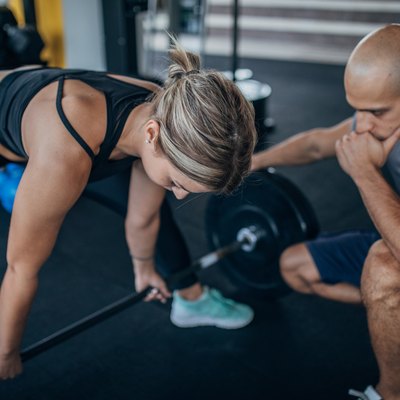 Woman practicing dead lifting