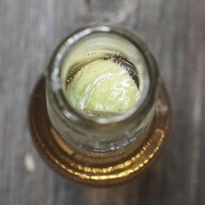 High Angle View Of Beer Bottle With Lemon Slice On Table
