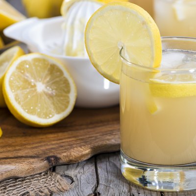 Arrangement of glass with fresh lemonade with ingredients