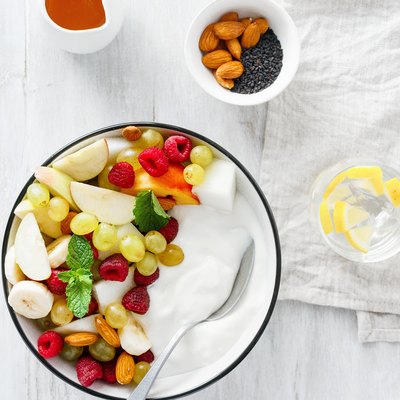 Top view full fruit breakfast and natural yoghurt bowl