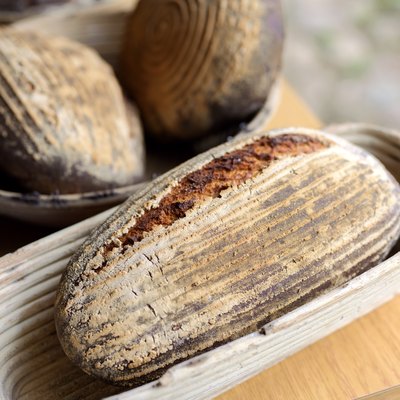 freshly baked bread from the stone oven lying in baskets to cool down