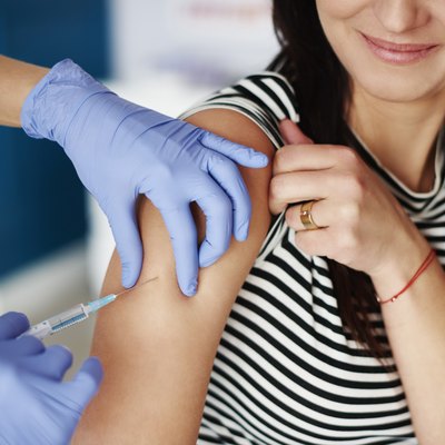 Woman receiving an injection in her arm