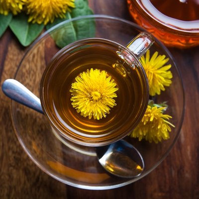 dandelion tisane tea with yellow blossom inside teacup